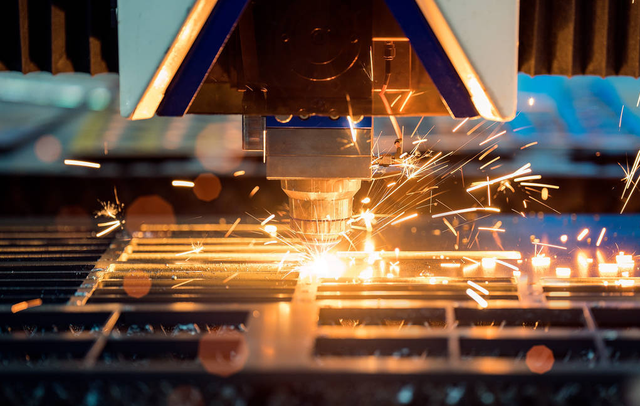 Laser cutting a metal sheet with sparks