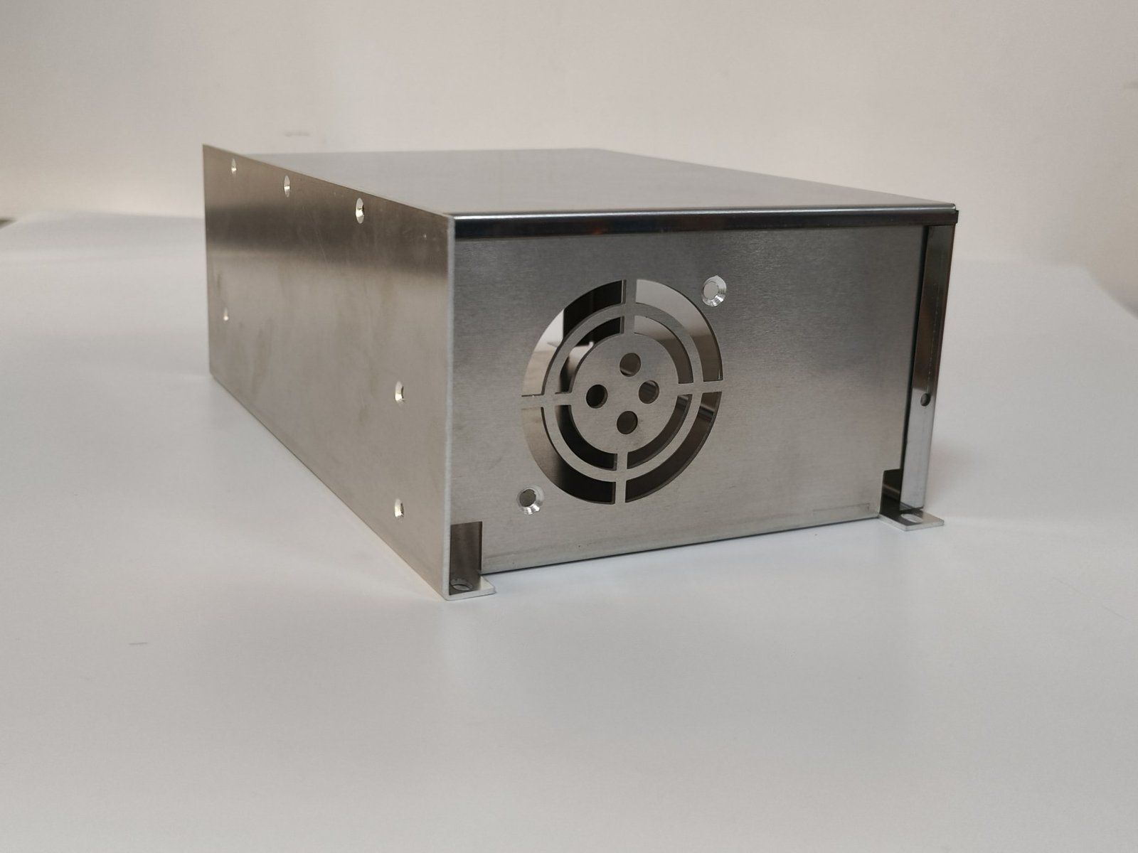 sheet metal capabilities - A stainless steel chassis with a fan aperture, louvred vents and fixing holes, laser cut and formed from 1.5 mm sheet.