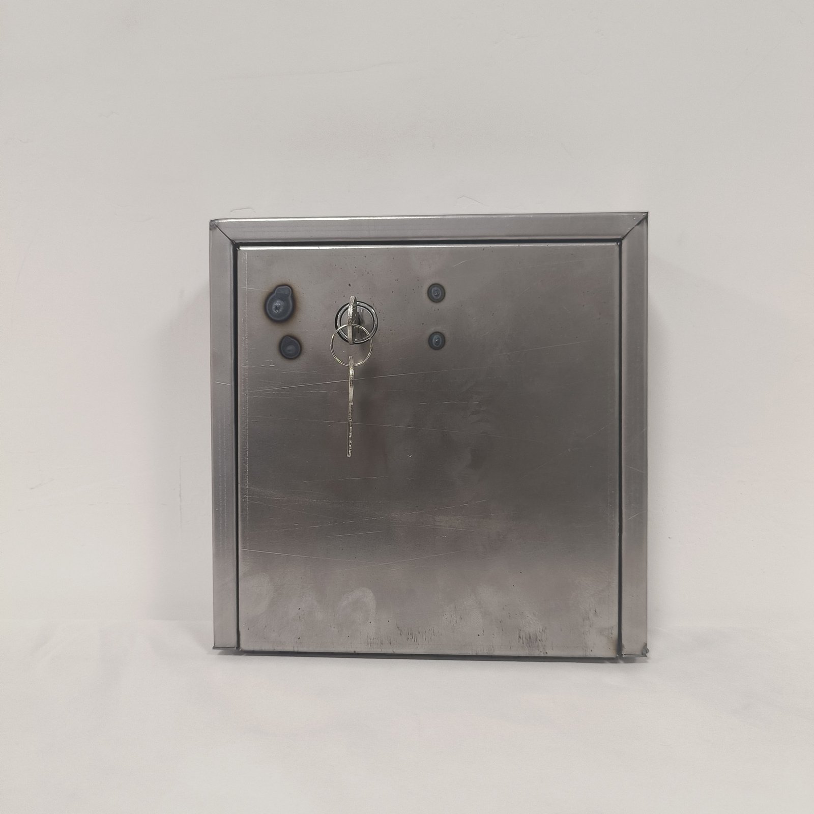 stainless steel letterbox - A brushed stainless steel letterbox with a horizontal posting slot and a central keyed lock.
