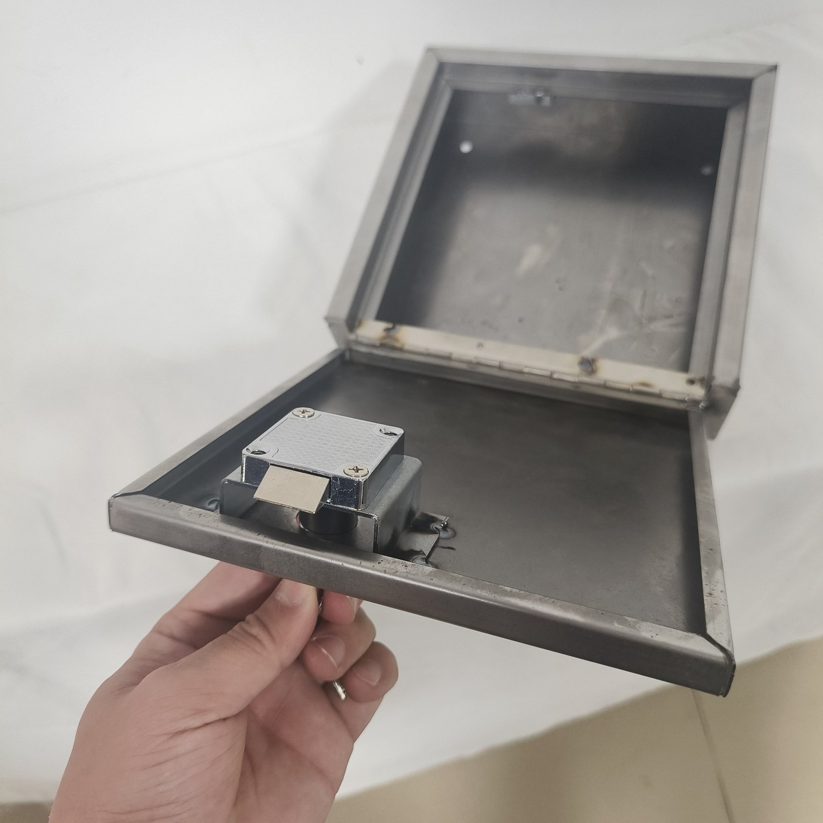 stainless steel letterbox - The chamber open, showing the internal baffle and the slot geometry that keeps posted items out of reach.
