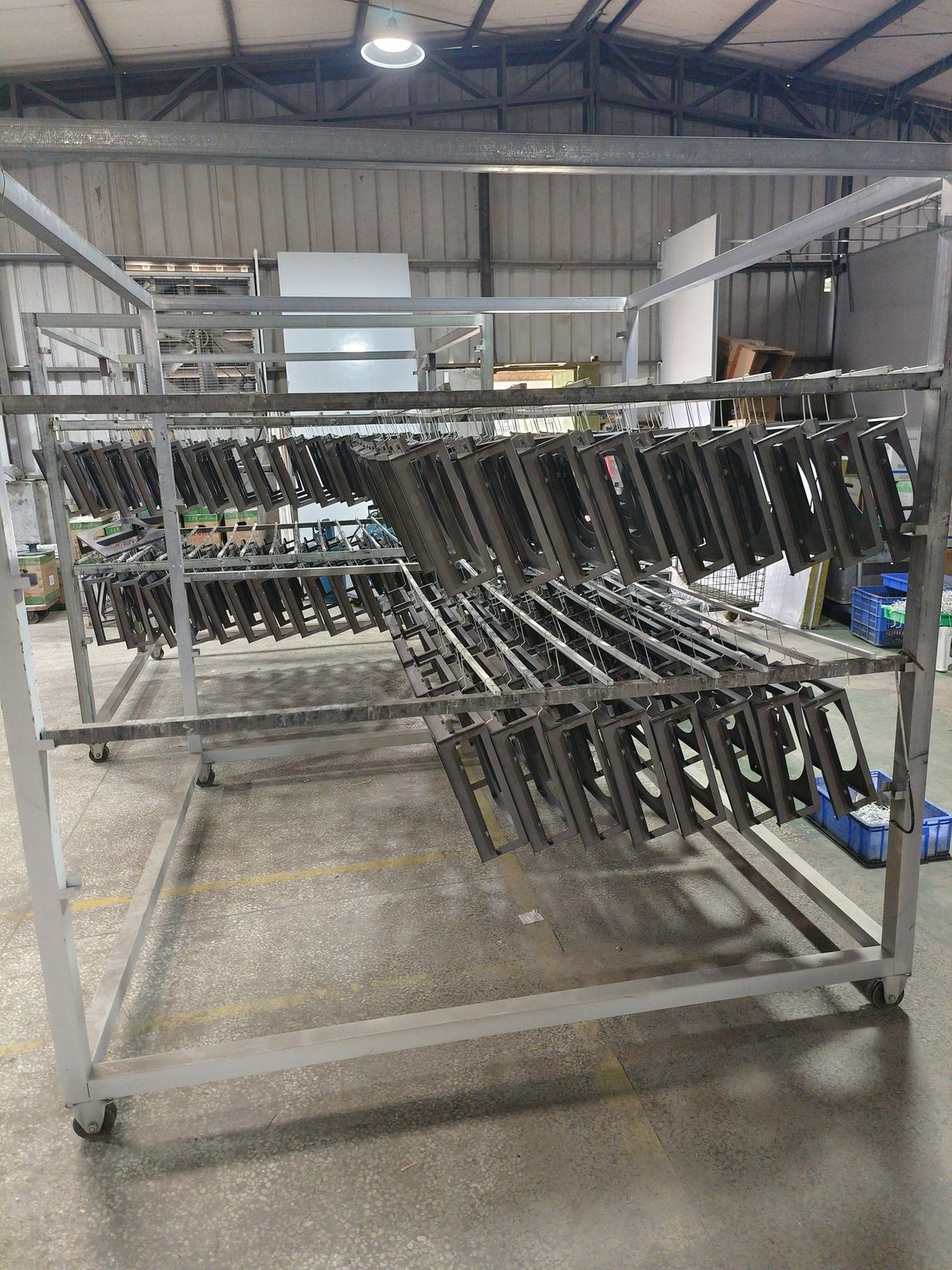 stainless steel letterbox - A production batch of stainless steel letterboxes on a rack, ready for finishing and packing.