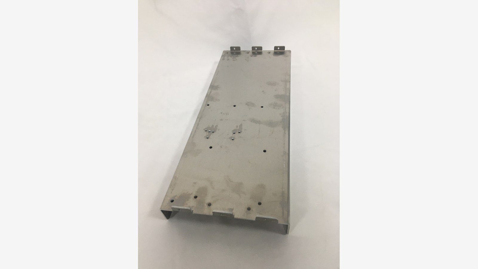 cnc punching service - A production punched part in 2 mm steel showing hole position accuracy and formed returns.
