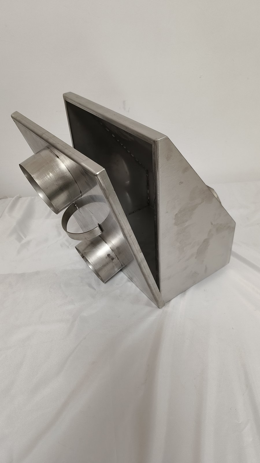 sheet metal welding - A welded sheet metal duct transition: tube outlets welded into a folded box body.